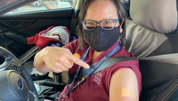 Woman shows she got a COVID-19 vaccine, San Diego, California, U.S., Sept. 2021.