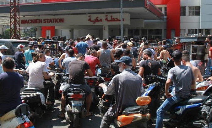 People wait to refuel at a gas station in Tripoli, northern Lebanon, Aug. 25, 2021.