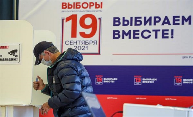 A citizen fills in his ballot at a polling station, Moscow, Russia, Sept. 17, 2021.