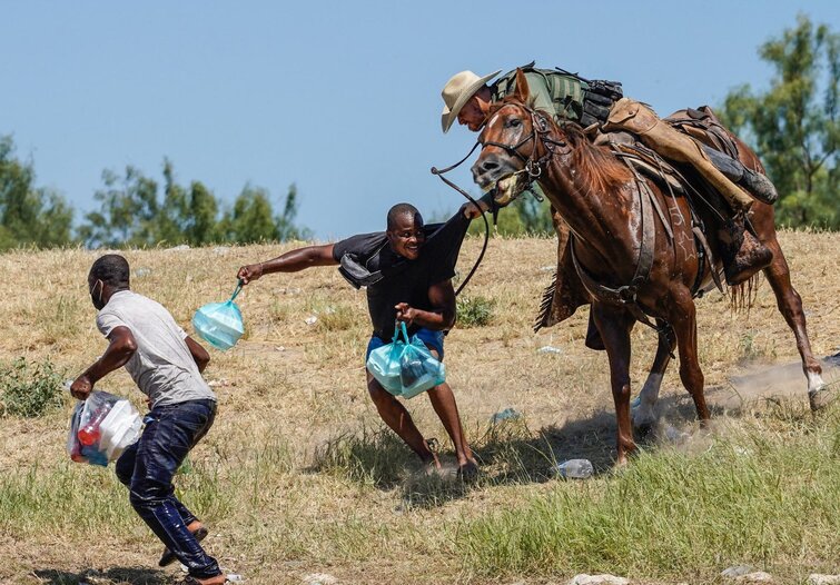 A U.S. Border Patrol agent on horseback tries to stop a Haitian migrant from entering an encampment on the banks of the Rio Grande near the Acuna Del Rio International Bridge in Del Rio, Texas on Sunday.