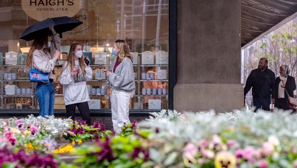 People wait outside a chocolate store in CBD of Sydney, Australia, on Oct. 11, 2021.