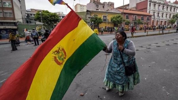 Woman waving A Bolivian flag.