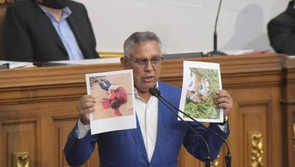 Lawmaker shows photos of murdered adolescents, National Assembly, Caracas, Venezuela, Oct. 14, 2021.
