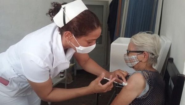 A woman gets a COVID-19 vaccine, Cuba, 2021. 