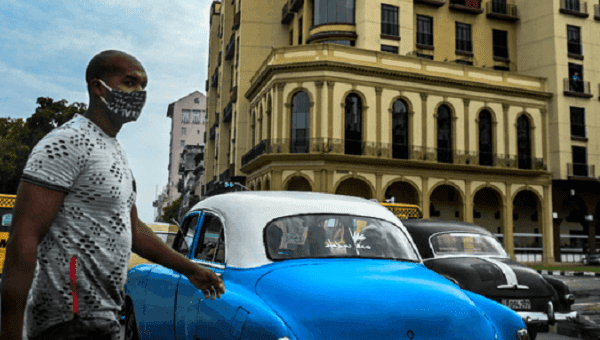 Citizen crosses a street, Havana, Cuba, 2021.