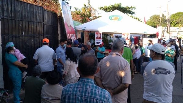 People wait in long lines for the opening of a voting center in La Ceiba, Honduras, Nov. 28, 2021.