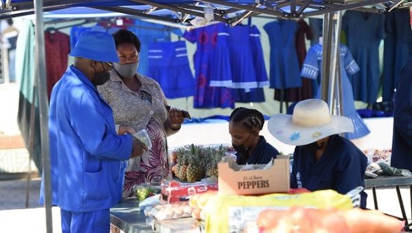 Citizens buy vegetables at a market in Gaborone, Botswana, Dec. 8, 2021.