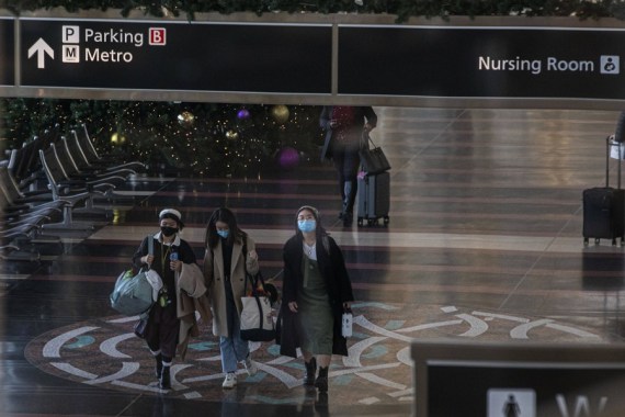 Passengers wearing face masks are seen at Ronald Reagan Washington National Airport in Arlington, Virginia, the United States, Dec. 4, 2021.