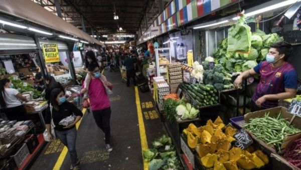 People walk in a market in Santiago, Chile, March 30, 2021.