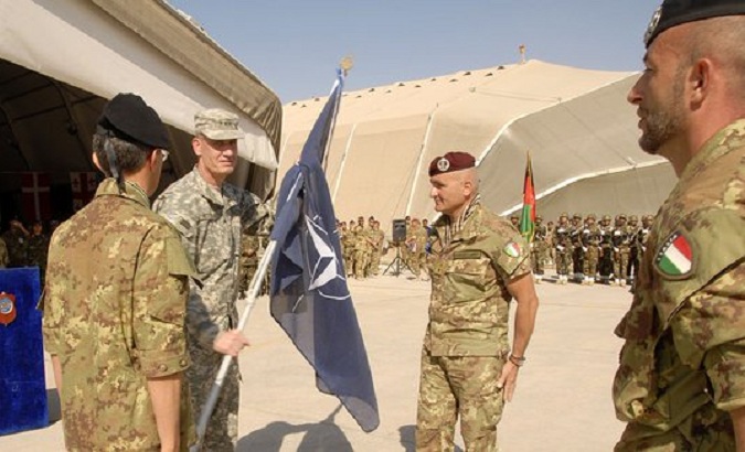 File photo of a soldier holding a NATO flag