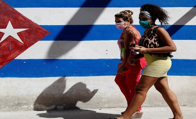Citizens walking down a street, Havana, Cuba, January 2022.