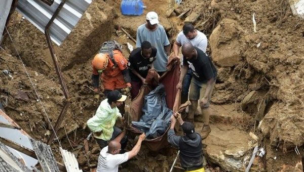 Citizens recover the body of a victim of the rains, Petropolis, Brazil, Feb. 17, 2022.
