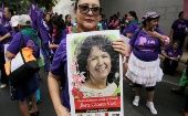 A woman shows a banner with the photo of Berta Caceres, Honduras. 