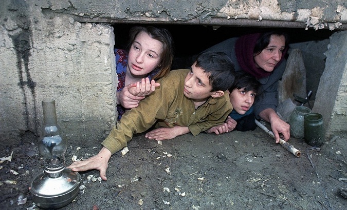 A family in a makeshift shelter protects itself from shelling in Donbass, Feb. 18, 2022.