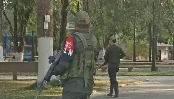 National Liberation Army (ELN) members patrol a town, Colombia. 