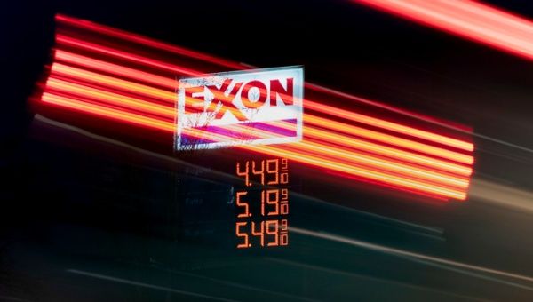 A long exposure photograph shows vehicles passing an Exxon gas station in Washington, DC, USA, 09 March 2022.
