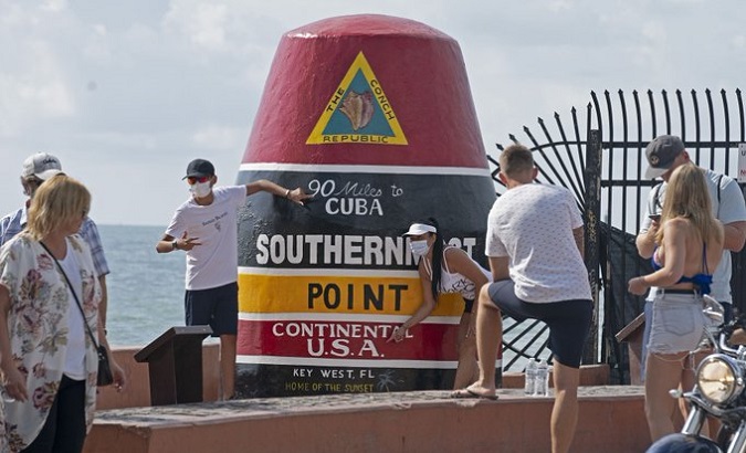 People gathering at the Southernmost Point marker in Key West, Florida, U.S.