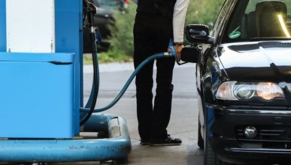 A customer fuels a vehicle at a gas station in Berlin, capital of Germany, on Oct. 1, 2021. 