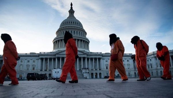 Demonstrators dressed in Guantanamo Bay prisoner uniforms, Washington DC, U.S., 2020.