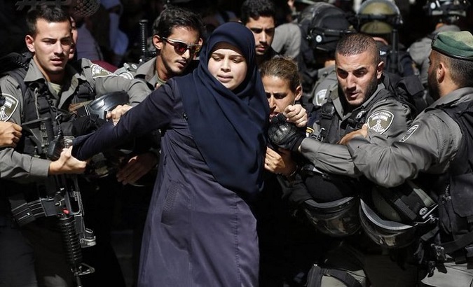 Israeli occupation forces attack a Palestinian woman, 2022.