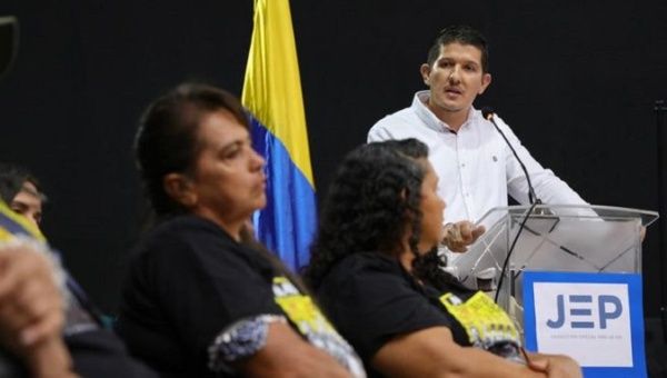 Colombian ex-Corporal Nestor Gutierrez (R) admits crimes before victims' relatives, April 26, 2022.
