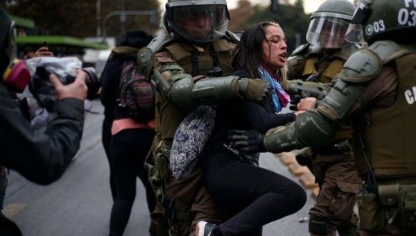 A citizen is detained by the military police, Santiago, Chile, May 1, 2022.