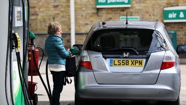 A woman fuels her car at a petrol station in London, Britain, April 8, 2022.