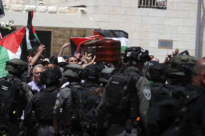 Mourners carry the coffin of slain American-Palestinian journalist Shireen Abu Akleh outside St. Joseph Hospital, ahead of a funeral procession in the Old City of Jerusalem