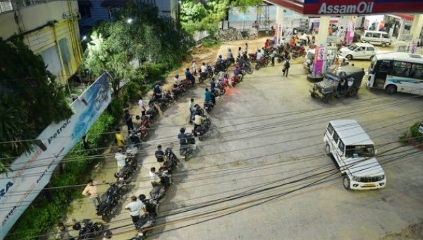 Motorcyclists wait for refilling at a fuel station in Agartala, the capital city of India's northeastern state of Tripura, May 18, 2022.
