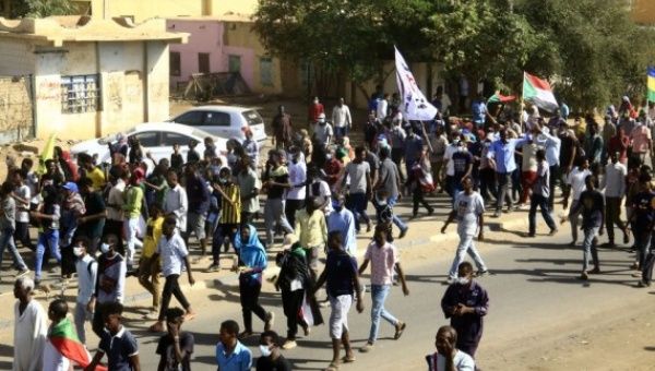 People demonstrate on a street demanding civilian rule in Khartoum, Sudan, Dec. 13, 2021.