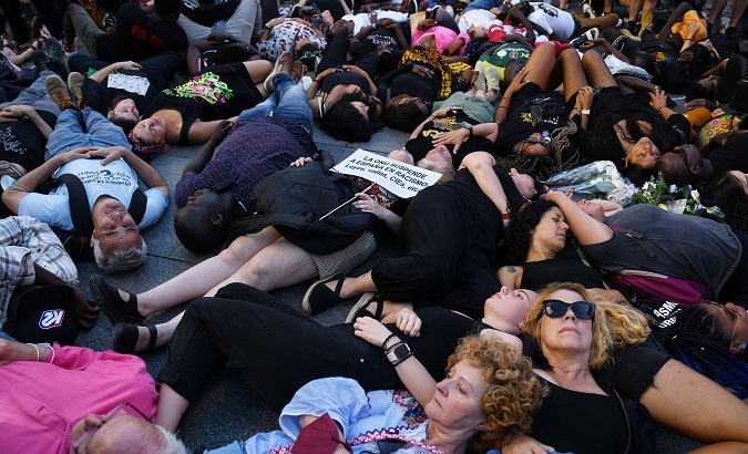 Protesters reproduce the position of Melilla massacre's victims, Madrid, June 26, 2022.
