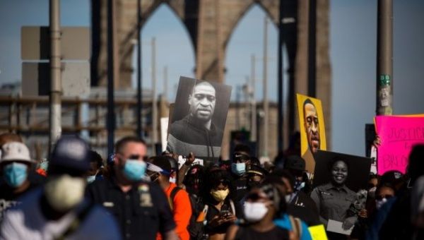 Demonstrators take part in a protest sparked by the death of George Floyd across the Brooklyn Bridge in New York, the United States, June 13, 2020.