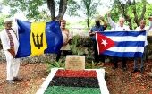 Activists raising the Cuban and Barbados flag over Israel Lovell