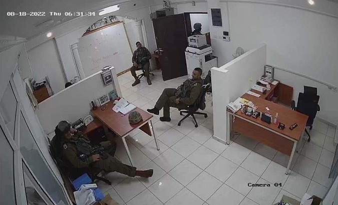 Israeli occupation forces inside a raided Palestinian NGO, Aug. 18, 2022.