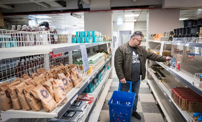 A Swede looks at the prices in a supermarket, May, 2022.