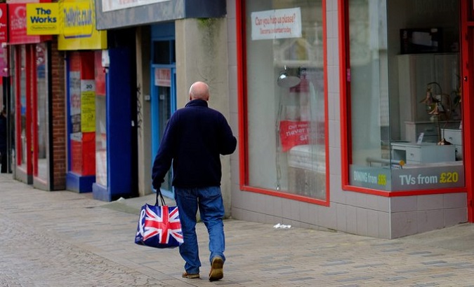 A man walks along an empty shopping street Blackpool, U.K, Sept. 23, 2022..