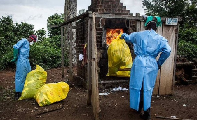 Health workers burn clothing infected with Ebola virus, 2022.