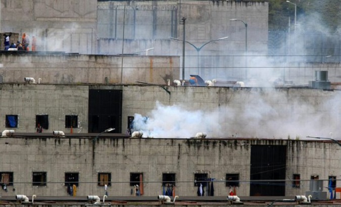 Tear gas and inmates on the roof of the prison, Latacunga, Ecuador, Sept. 4, 2022.