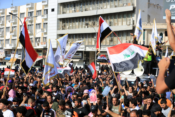 Iraqi protesters carry the Iraqi national flag during a protest at Tahrir square in central Baghdad, Iraq, 01 October 2022.