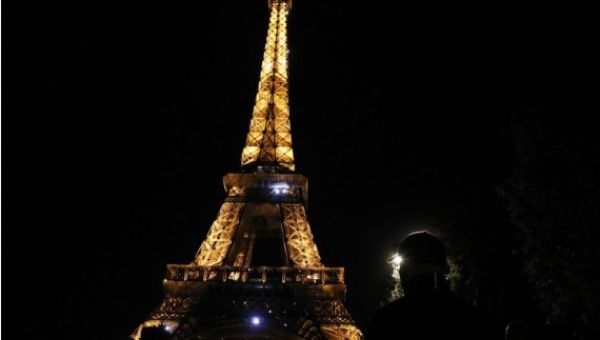 A man looks at the sparkling Eiffel Tower in Paris, France, Sept. 22, 2022.