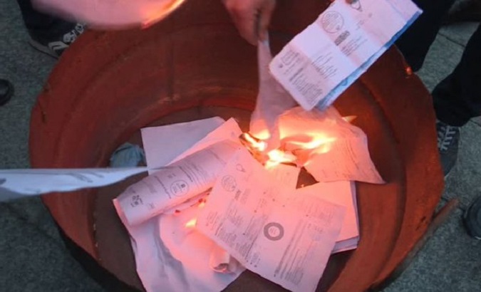 Italians protest against inflation by burning electricity bills, Oct. 2022.
