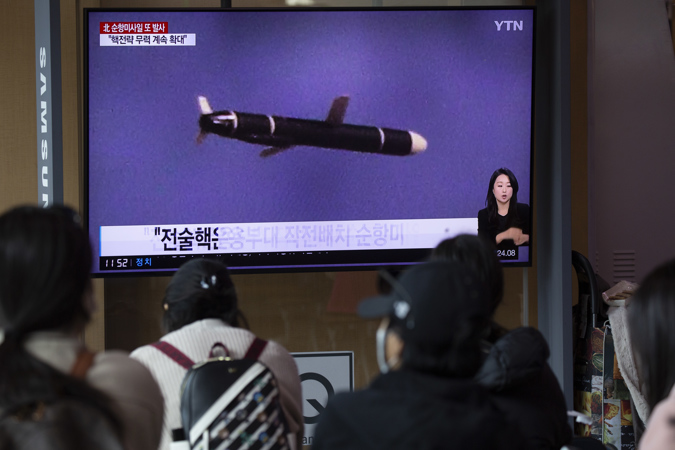People watch the news at a station in Seoul, South Korea, 13 October 2022.