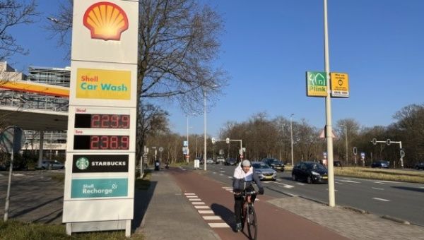 A cyclist passes a price board at a gas station in The Hague, the Netherlands, on March 9, 2022.