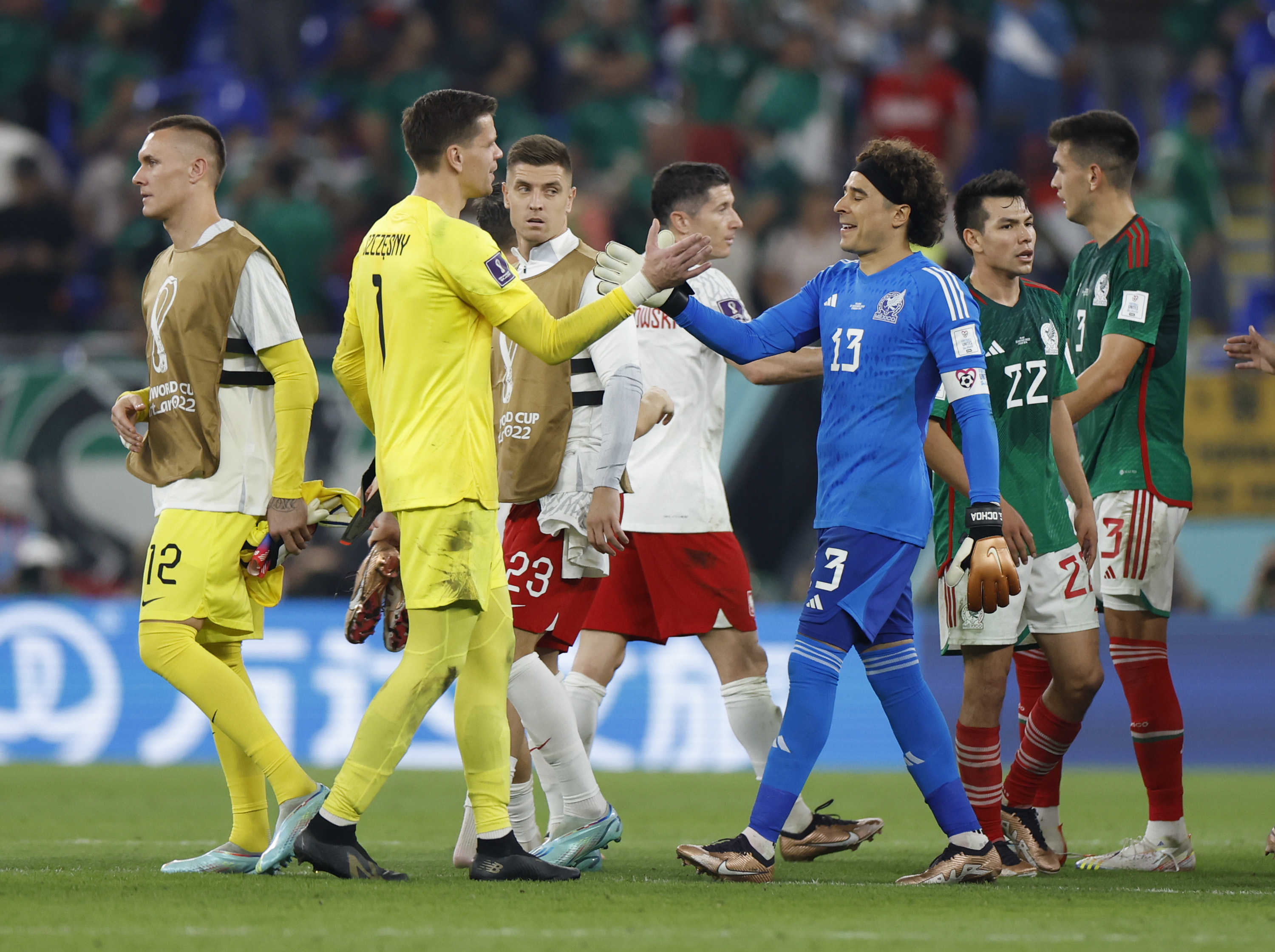 Guillermo Ochoa (R, front), goalkeeper of Mexico, vies with Wojciech Szczesny (L, front), goalkeeper of Poland, after the Group C match between Mexico and Poland of the 2022 FIFA World Cup at Ras Abu Aboud (974) Stadium in Doha, Qatar, Nov. 22, 2022.