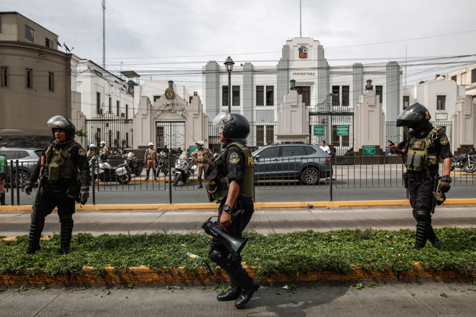 Police officers monitor the Prefecture where President Pedro Castillo is located today, in Lima