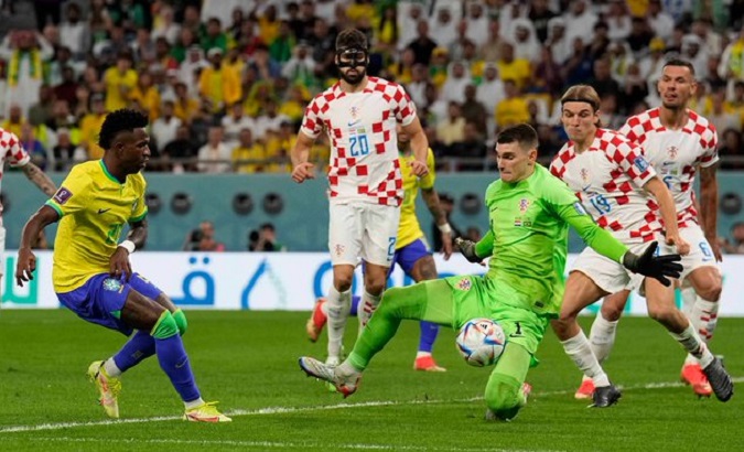 Croatia goalkeeper Dominik Livakovic saves a Brazilian shot, Dec. 9, 2022.