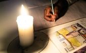 A student does his homework during a blackout.