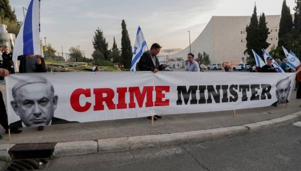 Israelis holding a banner during a demonstration against the government of Benjamin Netanyahu, which he seeks to form, as they block the entrance of the Israeli Knesset, in Jerusalem, 12 December 2022. 