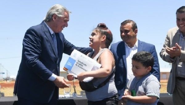 President Alberto Fernandez greets a citizen benefited from the 