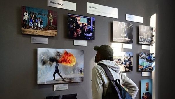A man observes the photos awarded by the Andrei Stenin Contest.